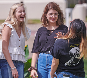 Decorative image of three PSC students talking together outside