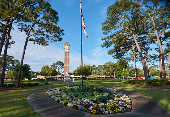 Pensacola State College Pensacola campus American flag pole in front of M.J. Menge Bell Tower